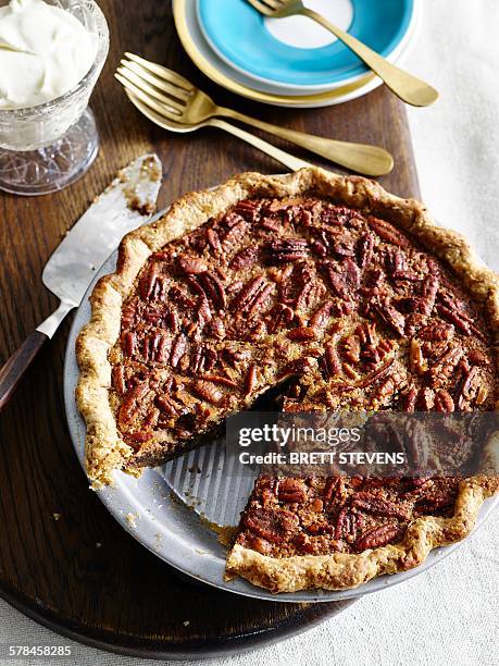high angle view of pecan pie with slice missing - pecan stock pictures, royalty-free photos & images