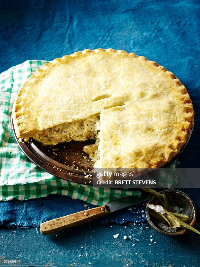 High angle view of lemon myrtle chicken pie, slice missing