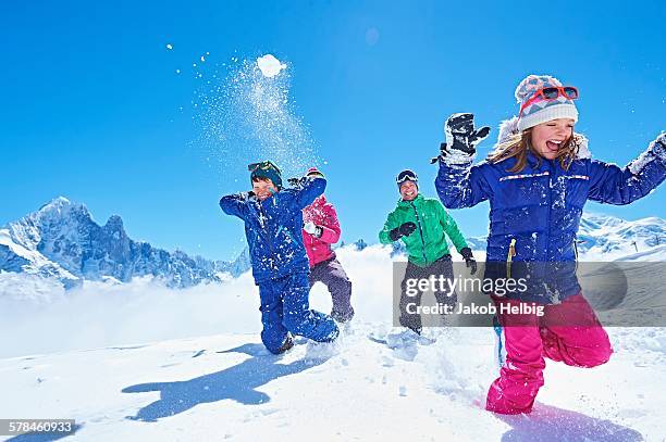 family having snowball fight, chamonix, france - family in snow mountain stockfoto's en -beelden