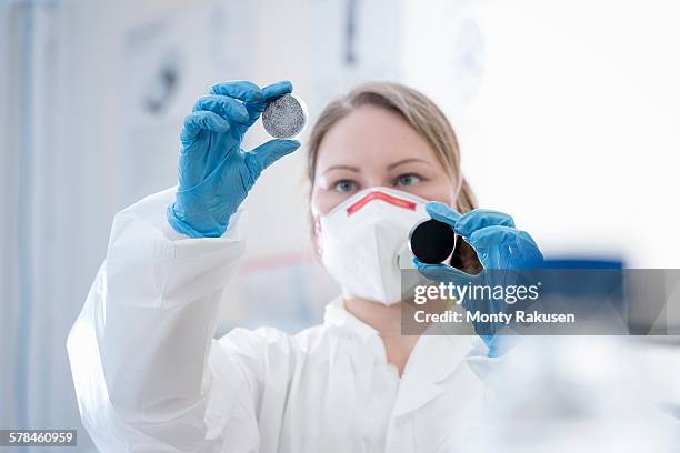 female scientist holding plasma enhanced dispersion samples of graphene in graphene processing factory - graphite stock pictures, royalty-free photos & images