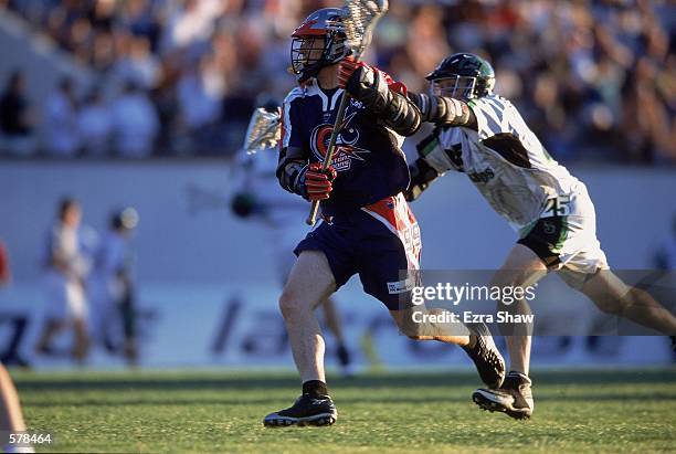 Greg Traynor of the Boston Cannons runs as Steven Sambrotto of the Long Island Lizards is right behind him during the Major League Lacrosse game at...