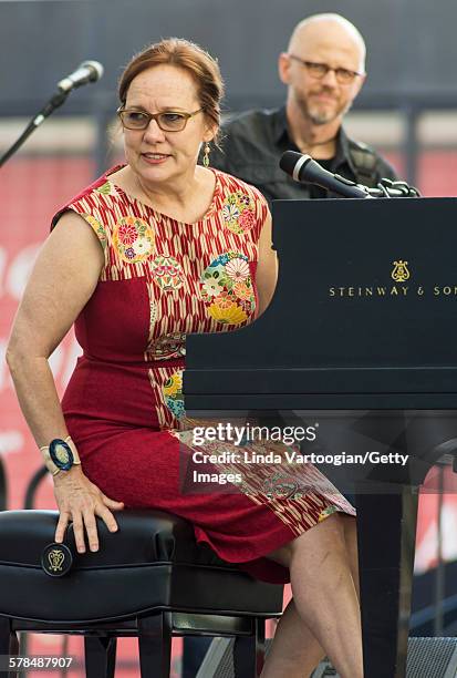 American Country and Folk musician Iris DeMent plays piano with her band with at the Lincoln Center Out of Doors Americanafest NYC on Hearst Plaza,...