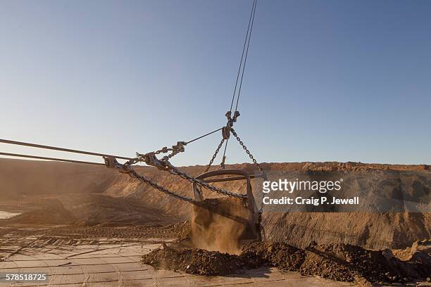 mining  dragline bucket in action - excavator mining action stock-fotos und bilder