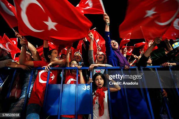 Citizens wave Turkish Flags as they gather at Konak Square during a demonstration, staged to protest and to show solidarity against Parallel...