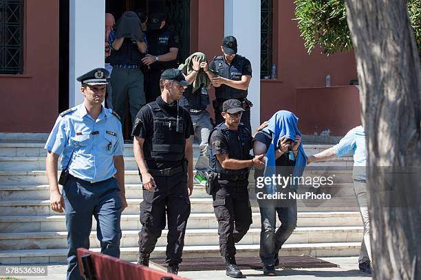 Greek police officer escorts a Turkish officer who fled to Greece by helicopter after last week's failed coup, as he leaves the courthouse of...