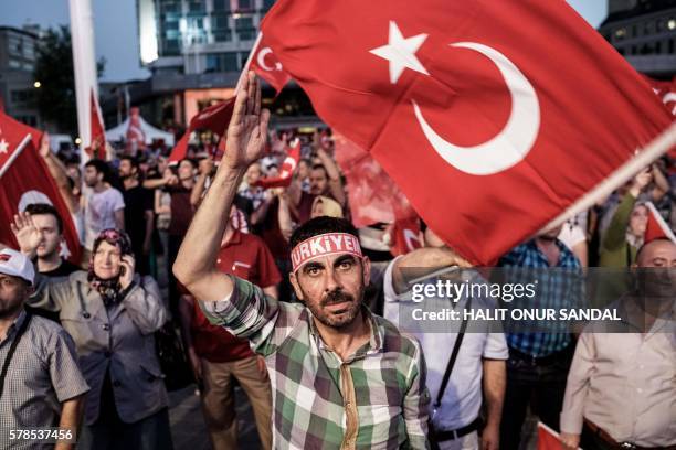 Pro Erdogan supporters wave Turkish national flags during a rally at Taksim square in Istanbul of July 15. Thousands of Turkish government supporters...