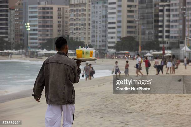 Rio de Janeiro, Brazil, 21 July 2016: Man sells Caipirinha on Copacabana Beach. Caipirinha is a Brazilian typical drink made with citrus fruits and...