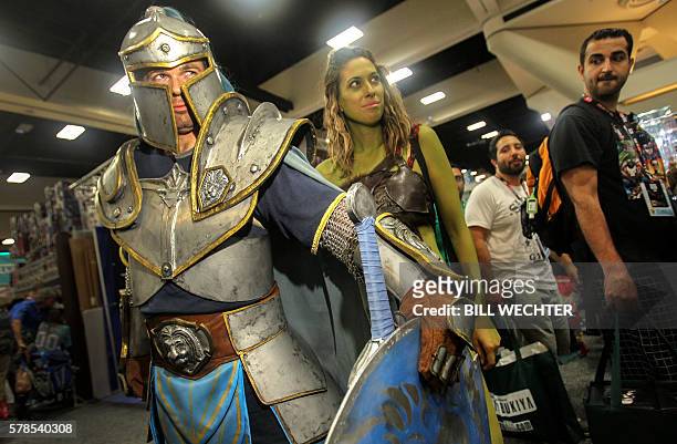 Foot soldier from the movie Warcraft guards the character Garona, center, during Comic-Con International 2016 in San Diego, California on July 21,...