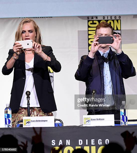 Actors Cara Delevingne and Dane DeHaan take photos at the "Valerian And The City Of A Thousand Planets" panel during Comic-Con International 2016 at...