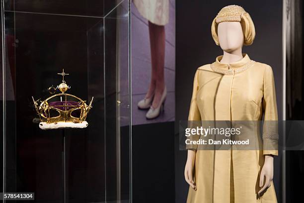 An outfit worn by Queen Elizabeth II for the investiture of Prince Charles in 1969 is displayed next to a Gold, Diamond and Platinum Corenet worn on...