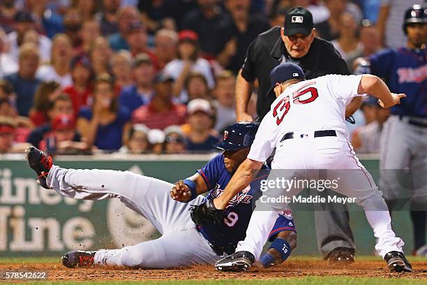 Kennys Vargas of the Minnesota Twins slides safely into home past Steven Wright of the Boston Red Sox during the fifth inning at Fenway Park on July...