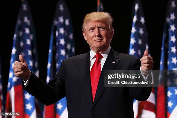 Republican presidential candidate Donald Trump gives two thumbs up to the crowd during the evening session on the fourth day of the Republican...