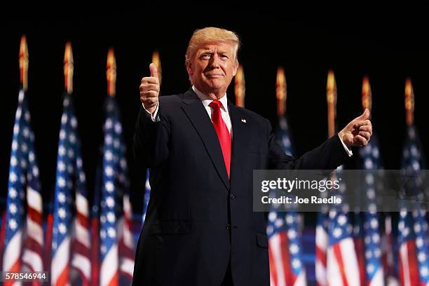 Republican presidential candidate Donald Trump gives two thumbs up to the crowd during the evening session on the fourth day of the Republican...