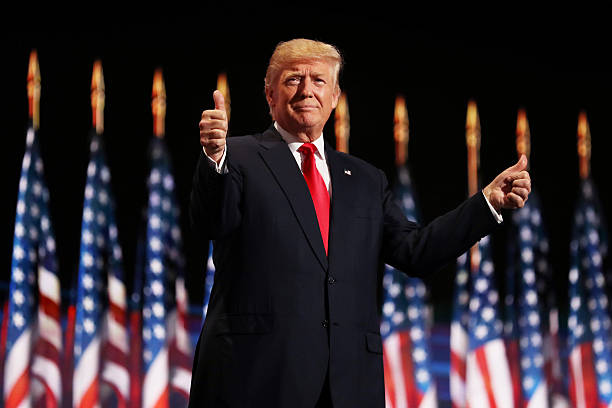 Republican presidential candidate Donald Trump gives two thumbs up to the crowd during the evening session on the fourth day of the Republican...