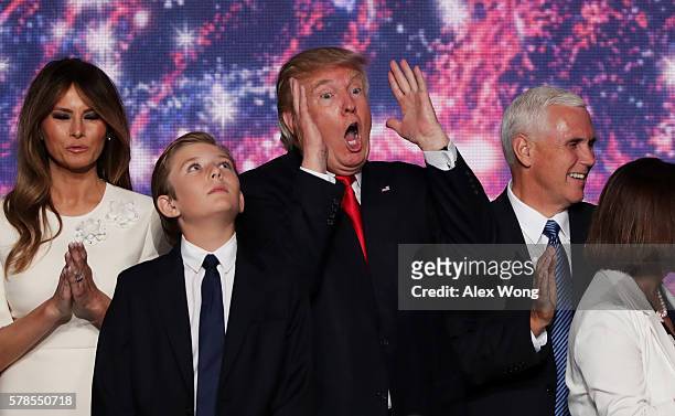 Republican presidential candidate Donald Trump reactes as Republican vice presidential candidate Mike Pence , Barron Trump and his wife Melania Trump...