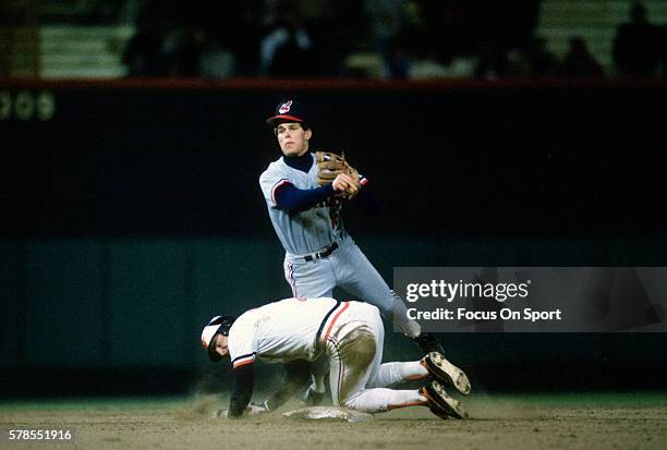 Jay Bell of the Cleveland Indians gets his throw off over the top of Billy Ripken of the Baltimore Orioles during an Major League Baseball game circa...