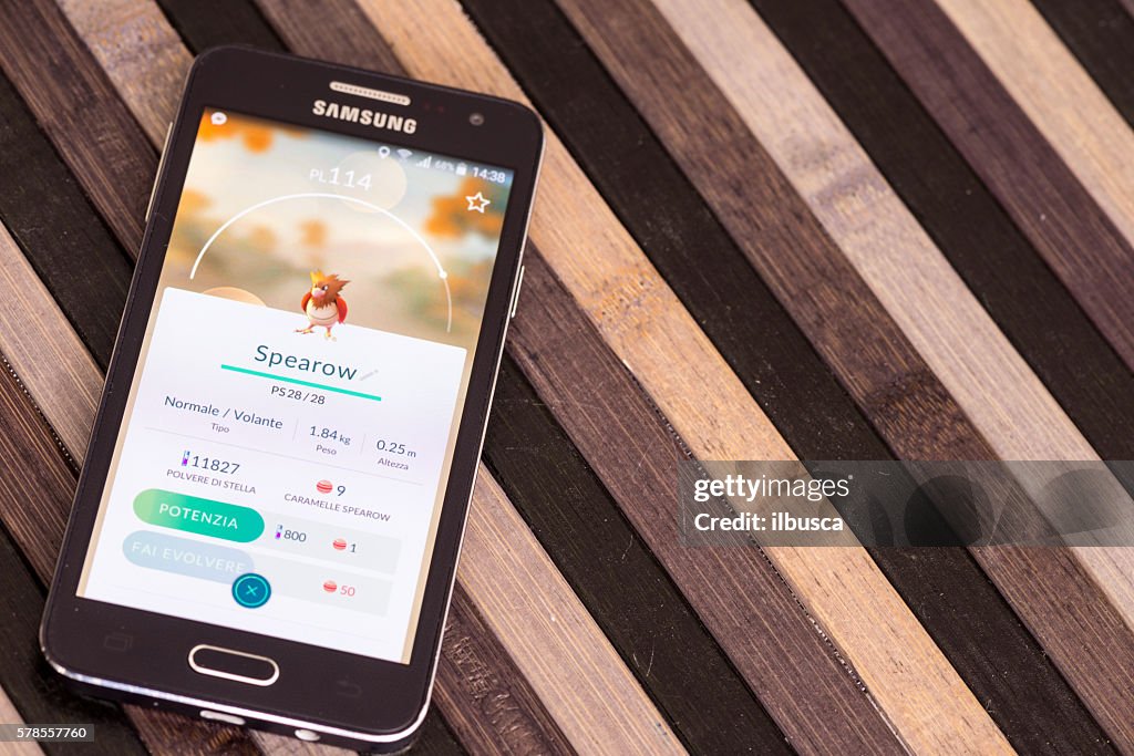 Pokemon go on Samsung smartphone on striped wood table