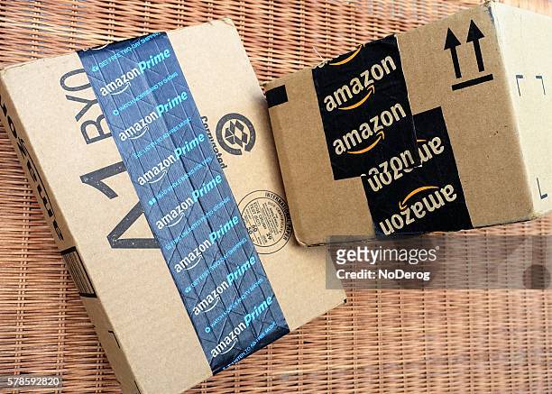 amazon shipping packages with prime packing tape - amazon package stock pictures, royalty-free photos & images