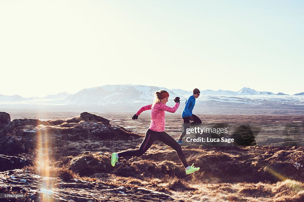 Male and Female free running through mountains