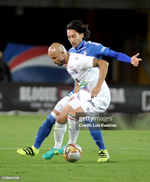 Rafael Robayo of Millonarios vies for the ball with Elkin Soto of Once Caldas during a match between Millonarios and Once Caldas as part of round 11...