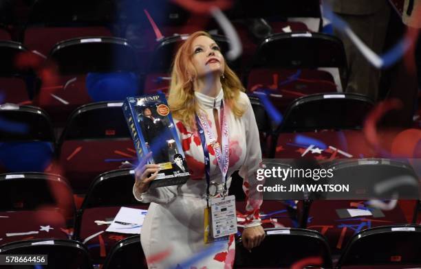 Delegate holds a Trump doll as she looks up after the final night of the Republican National Convention at the Quicken Loans Arena in Cleveland, Ohio...