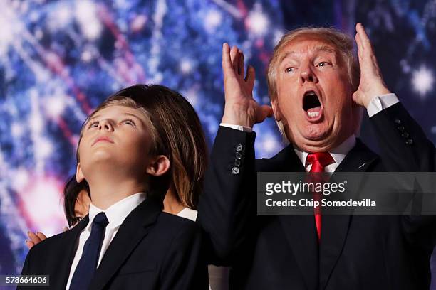 Republican presidential candidate Donald Trump reacts as his son Barron Trump looks on at the end of the Republican National Convention on July 21,...