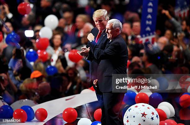 Republican presidential candidate Donald Trump and Republican vice presidential candidate Mike Pence acknowledge the crowd at the end of the...