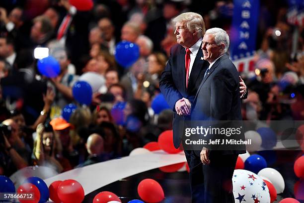 Republican presidential candidate Donald Trump and Republican vice presidential candidate Mike Pence acknowledge the crowd at the end of the...