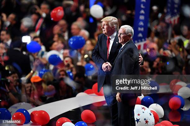 Republican presidential candidate Donald Trump and Republican vice presidential candidate Mike Pence acknowledge the crowd at the end of the...