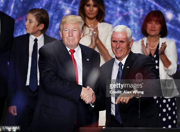 Republican presidential candidate Donald Trump and Republican vice presidential candidate Mike Pence shake hands at the end of the Republican...
