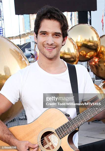 Host Tyler Posey plays the guitar at the MTV Fandom Awards San Diego at PETCO Park on July 21, 2016 in San Diego, California.