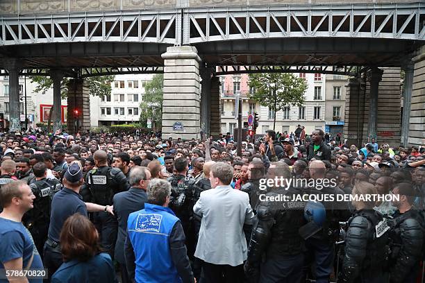 Migrants are evicted from a makeshift camp by French gendarmes, on July 22, 2016 in Paris. Between 1,200 and 1,400 people, mostly men, from Eritrea,...