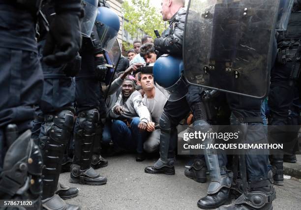 Migrants are evicted from a makeshift camp by French gendarmes, on July 22, 2016 in Paris. Between 1,200 and 1,400 people, mostly men, from Eritrea,...