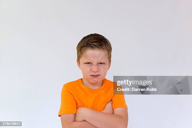 young boy frowning with a grumpy expression - boy with dark hair blue eyes bildbanksfoton och bilder