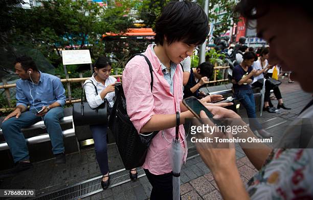 People play Pokemon Go game on smartphones on July 22, 2016 in Tokyo, Japan. The Japanese version of the game app Pokemon Go was released on July 22,...