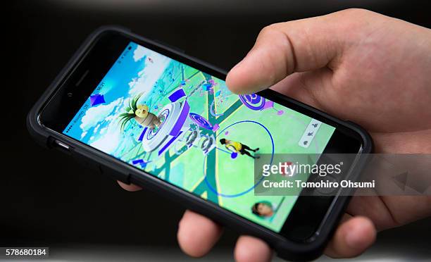 Man plays Pokemon Go game on a smartphone on July 22, 2016 in Tokyo, Japan. The Japanese version of the game app Pokemon Go was released on July 22,...
