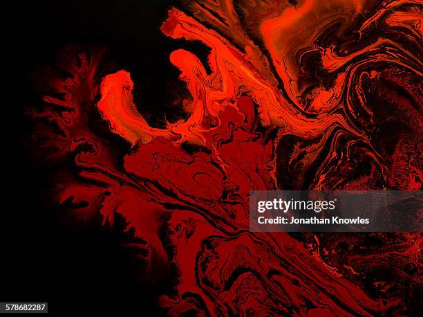 red marbling paint on black background - splatter stock pictures, royalty-free photos & images