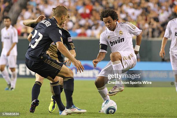 Real Madrids Marcelo Vieira shows fancy footwork as he dribbles past Unions Ryan Richter during the World Football Challenge friendly match between...