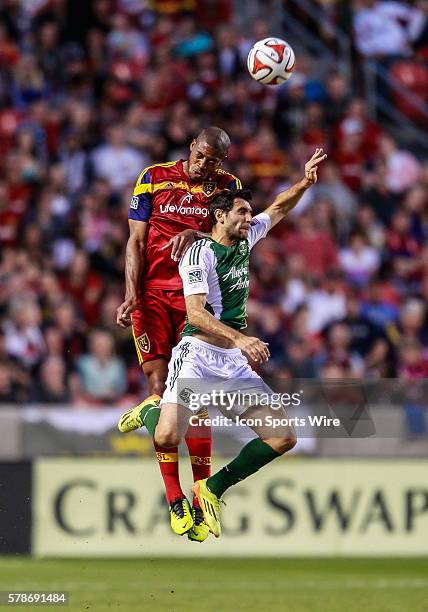 Real Salt Lake defender Chris Schuler battles with Portland Timbers midfielder Diego Valeri for a header during the MLS game between Real Salt Lake...