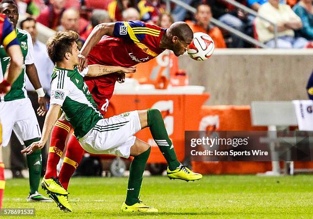 Real Salt Lake defender Chris Schuler dives for a header over Portland Timbers midfielder Maximiliano Urruti during the MLS game between Real Salt...