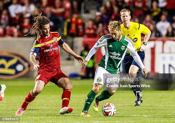 Portland Timbers forward Gaston Fernandez battles against the defense of Real Salt Lake midfielder Kyle Beckerman during the MLS game between Real...