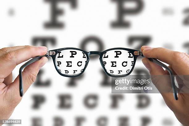 spectacles focussed on eye test chart - eye test stock pictures, royalty-free photos & images