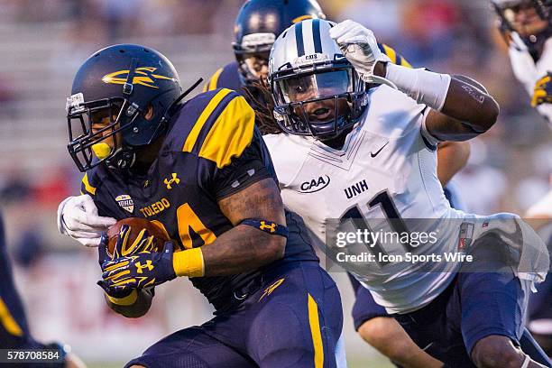 New Hampshire Wildcats safety Tre Williams attempts to tackle Toledo Rockets running back Damion Jones-Moore during game action between the New...