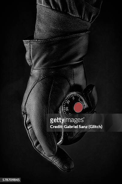 hand with black glove holding a padlock - black glove stock pictures, royalty-free photos & images