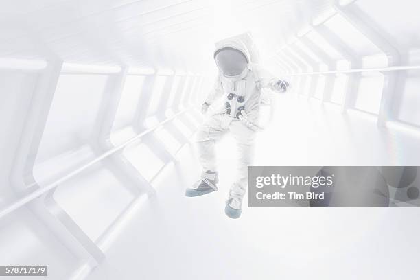 astronaut floating through tunnel - astronaut potrait stock-fotos und bilder