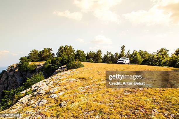 adventure travel around the pyrenees mountains driving with suv car to the top of the mountains with nice views on sunset. - suv berg stock-fotos und bilder