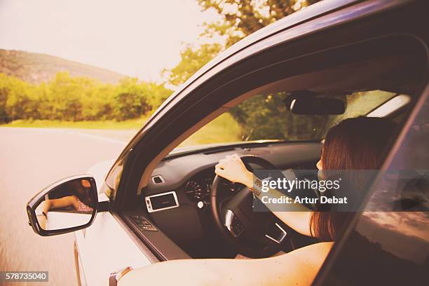 family mother driving a suv car during a road trip travel through the catalan pyrenees roads. - suv berg stock-fotos und bilder