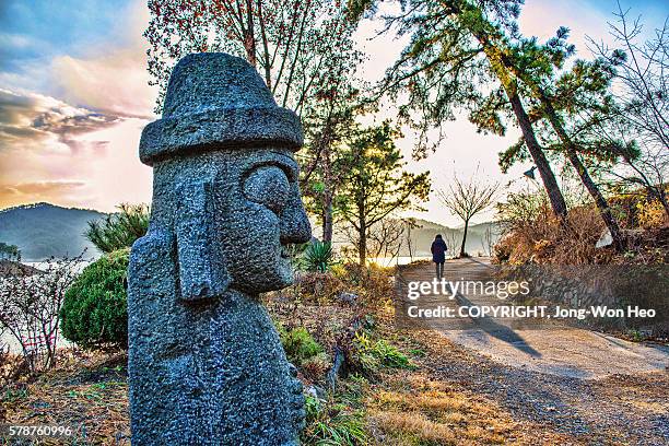 a big basalt doll saying 'bye' to a leaving woman - daejeon stock pictures, royalty-free photos & images