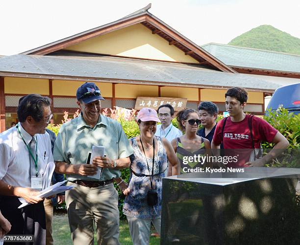 Japan - U.S. Ambassador to Japan John Roos looks at the writing on a monument contributed by former U.S. Ambassador to Japan Edwin Reischauer at...