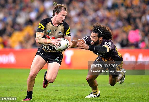 Matt Moylan of the Panthers breaks away from the defence of Adam Blair of the Broncos during the round 20 NRL match between the Brisbane Broncos and...